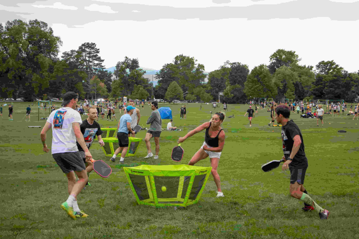 A group of friends are energetically playing PaddleSmash on a tournament