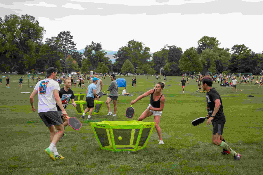 A group of friends are energetically playing PaddleSmash on a tournament