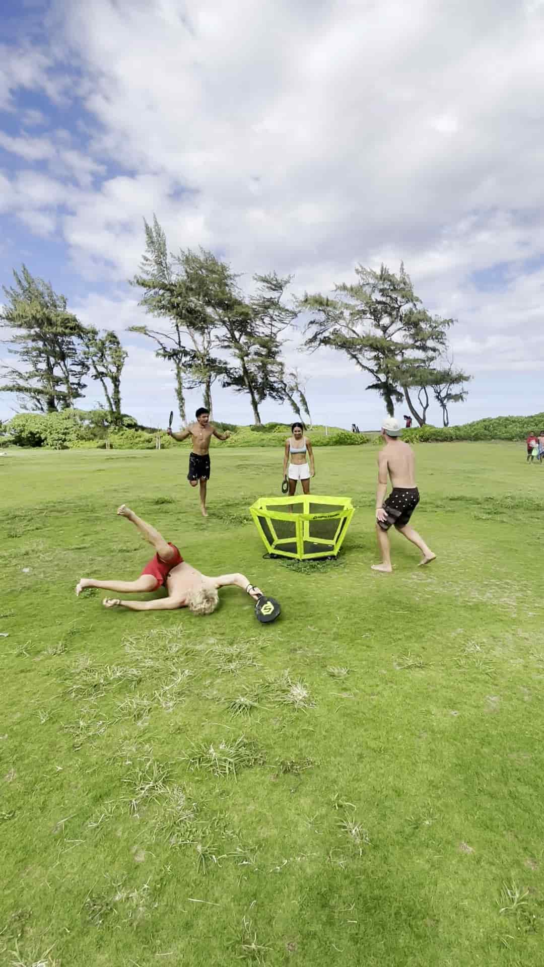 Happy friends energetically playing during summer 