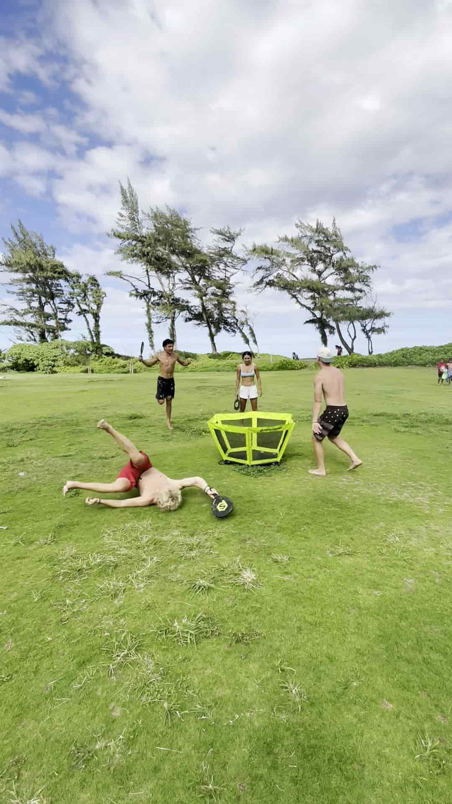 Happy friends energetically playing during summer 