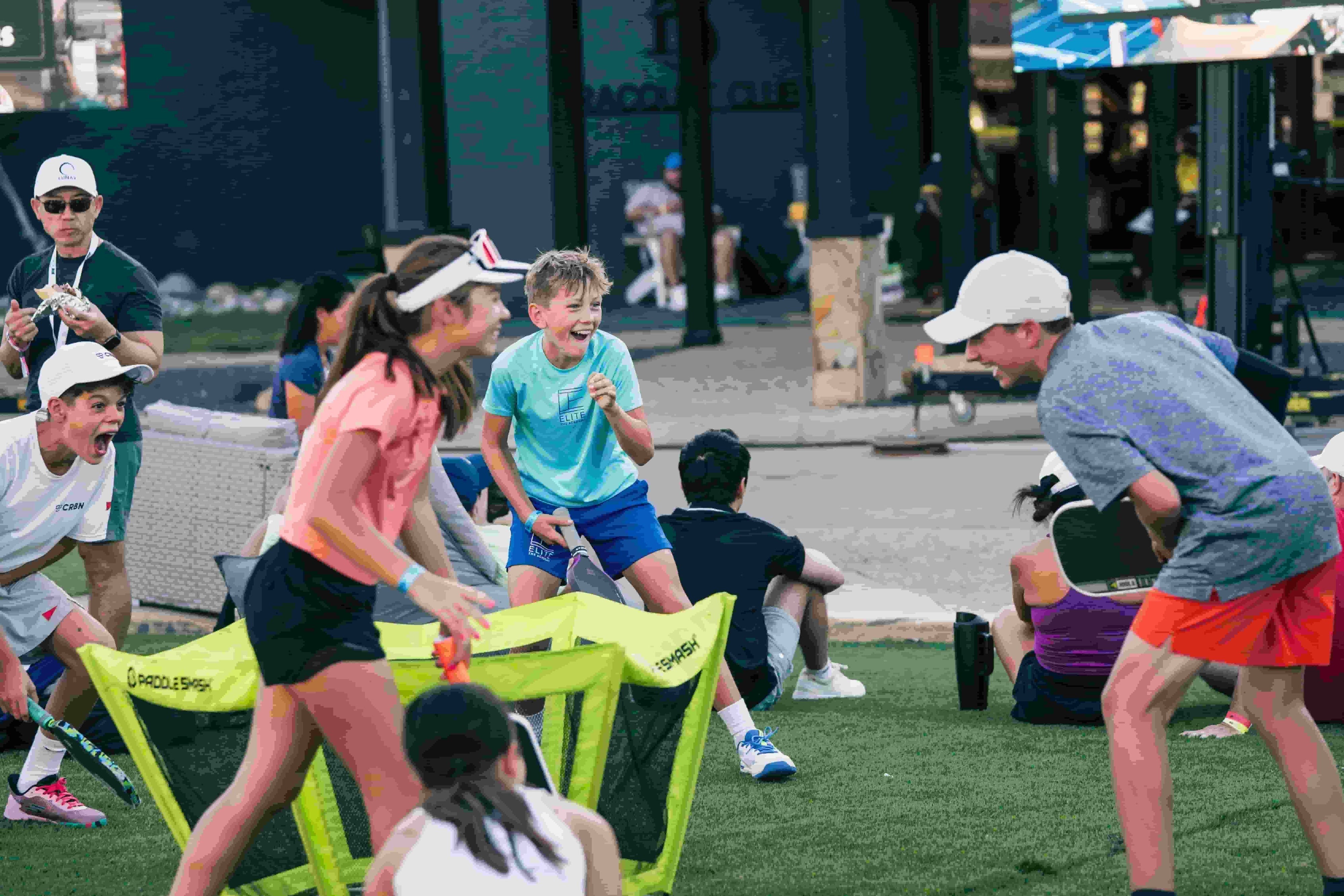 A group of kids laughing hysterically while playing PaddleSmash